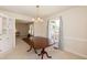 Dining room with a large table, chandelier, window and built-in cabinetry at 303 Spring St, Louisburg, NC 27549