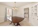 Traditional dining room with a classic table, chandelier, and natural light at 303 Spring St, Louisburg, NC 27549