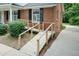 Wooden ramp leads to a red brick home with black shuttered windows at 303 Spring St, Louisburg, NC 27549