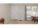 Bright foyer with a white front door, a sunny window, and neutral wall color at 303 Spring St, Louisburg, NC 27549