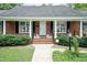 Charming single story brick home with inviting front porch and walkway at 303 Spring St, Louisburg, NC 27549