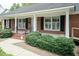 Welcoming front porch featuring brick stairs and black shutters for a classic look at 303 Spring St, Louisburg, NC 27549