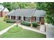 Charming home with lush lawn, mature trees, and convenient handicap access ramp at 303 Spring St, Louisburg, NC 27549