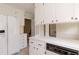 Bright kitchen features white cabinets, stainless steel sink, and modern appliances at 303 Spring St, Louisburg, NC 27549