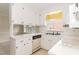 Bright kitchen features white cabinets, stainless steel sink, and modern appliances at 303 Spring St, Louisburg, NC 27549