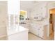 Bright kitchen with white cabinets, countertops, and modern appliances at 303 Spring St, Louisburg, NC 27549