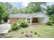 Back exterior with attached carport and brick-and-white exterior at 303 Spring St, Louisburg, NC 27549