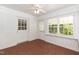 Enclosed sunroom with brick flooring, ample windows, and a ceiling fan for comfort at 303 Spring St, Louisburg, NC 27549