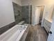 Luxurious bathroom with a soaking tub, tiled shower, and double sink vanity for modern comfort at 3191 Mission Olive Pl # 350, New Hill, NC 27562