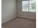 Cozy bedroom with neutral carpeting and a window bringing in lots of natural light and outside views at 3191 Mission Olive Pl # 350, New Hill, NC 27562