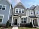 Attractive townhouse row featuring varied siding colors, complementary trim, and inviting entryways at 3191 Mission Olive Pl # 350, New Hill, NC 27562
