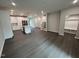 Expansive living room with hardwood floors, a modern kitchen, and a convenient mudroom area at 3191 Mission Olive Pl # 350, New Hill, NC 27562