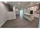 Spacious living room boasts hardwood floors, open layout, and access to a modern kitchen and staircase at 3191 Mission Olive Pl # 350, New Hill, NC 27562