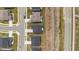 Overhead perspective of orderly neighborhood with similar homes, grassy yards, and structured roads, showcasing community at 3500 Bailey Lake Dr, Fuquay Varina, NC 27526