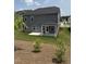 Exterior of home with a covered patio, complemented by a lush, green lawn and well-kept landscaping at 3500 Bailey Lake Dr, Fuquay Varina, NC 27526