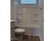 Well-lit bathroom featuring a shower-tub combo and built-in shelving at 3500 Bailey Lake Dr, Fuquay Varina, NC 27526