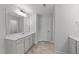 Well-lit bathroom with a vanity, mirror, and ample cabinet space, plus tile floors at 3500 Bailey Lake Dr, Fuquay Varina, NC 27526