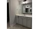 Bathroom highlighting a vanity with a stone countertop, mirror, lighting, and cabinet storage at 3500 Bailey Lake Dr, Fuquay Varina, NC 27526