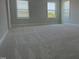 Well-lit bedroom with large windows, soft carpeting, and neutral paint, ready for decor at 3500 Bailey Lake Dr, Fuquay Varina, NC 27526