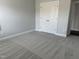 Neutral bedroom features two door closet, new carpet, and a door to another room at 3500 Bailey Lake Dr, Fuquay Varina, NC 27526