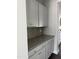 Convenient butler's pantry with elegant cabinets, granite counters, and backsplash, offering ample storage and style at 3500 Bailey Lake Dr, Fuquay Varina, NC 27526