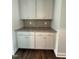 Butler pantry with white cabinets, granite countertop, and stylish backsplash, offering storage and prep space at 3500 Bailey Lake Dr, Fuquay Varina, NC 27526