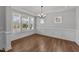Formal dining room with hardwood floors, recessed lighting, modern chandelier, and large windows at 3500 Bailey Lake Dr, Fuquay Varina, NC 27526