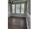 Bright dining area features hardwood floors, elegant wainscoting, and a large window with natural light at 3500 Bailey Lake Dr, Fuquay Varina, NC 27526