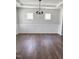 Formal dining room with hardwood floors, decorative wainscoting, and a stylish chandelier at 3500 Bailey Lake Dr, Fuquay Varina, NC 27526