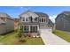 Charming two-story home featuring a two-car garage, manicured lawn, and welcoming covered porch at 3500 Bailey Lake Dr, Fuquay Varina, NC 27526