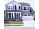 Charming two-story home features a modern gray exterior, well-manicured lawn, and attached two-car garage at 3500 Bailey Lake Dr, Fuquay Varina, NC 27526