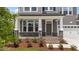 Charming front porch with stone details, brick accents, sturdy columns, and a lush, landscaped entryway at 3500 Bailey Lake Dr, Fuquay Varina, NC 27526