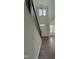 View of entry hall with dark wood stairway and railing leading to a room with large windows at 3500 Bailey Lake Dr, Fuquay Varina, NC 27526