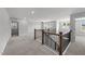 Open upstairs hallway boasts wood and iron banister with views to surrounding rooms at 3500 Bailey Lake Dr, Fuquay Varina, NC 27526