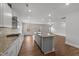 Open concept kitchen with central island, granite countertops, hardwood floors and stainless appliances at 3500 Bailey Lake Dr, Fuquay Varina, NC 27526