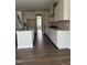 This is a kitchen with white cabinets, stainless steel appliances, and a granite countertop island, with hardwood floors at 3500 Bailey Lake Dr, Fuquay Varina, NC 27526