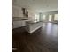 Open concept kitchen features granite counters, stainless steel appliances, a spacious island and hardwood floors at 3500 Bailey Lake Dr, Fuquay Varina, NC 27526