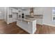 Modern kitchen features central island, granite countertops, stainless hood and appliances and hardwood floors at 3500 Bailey Lake Dr, Fuquay Varina, NC 27526