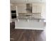Modern kitchen island with granite countertops, cabinets, and stainless steel appliances, perfect for cooking at 3500 Bailey Lake Dr, Fuquay Varina, NC 27526