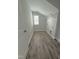 Functional laundry room with modern vinyl flooring and built in wire rack shelving at 3500 Bailey Lake Dr, Fuquay Varina, NC 27526