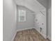 Bright laundry room featuring wood floors, a window, and a wire shelf at 3500 Bailey Lake Dr, Fuquay Varina, NC 27526