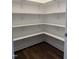 A well-organized pantry with multiple shelves provides ample storage space, complemented by hardwood floors at 3500 Bailey Lake Dr, Fuquay Varina, NC 27526