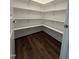 A well-organized pantry with multiple shelves provides ample storage space, complemented by hardwood floors at 3500 Bailey Lake Dr, Fuquay Varina, NC 27526