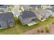Areal view of a two-story house with gray siding and a covered patio extending to the manicured lawn at 3500 Bailey Lake Dr, Fuquay Varina, NC 27526