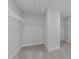 Large walk-in closet with wire shelving, neutral carpet, and bright white walls at 3500 Bailey Lake Dr, Fuquay Varina, NC 27526