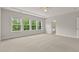 Bright bedroom with neutral carpet, large windows, and an en suite bathroom at 359 Abbot Pl, Chapel Hill, NC 27516