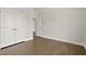 Bedroom with hardwood floors, white trim, and a double-door closet at 359 Abbot Pl, Chapel Hill, NC 27516