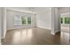 Spacious bedroom featuring hardwood floors, neutral paint, and large windows with natural light at 359 Abbot Pl, Chapel Hill, NC 27516