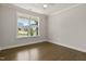 Bright bedroom with hardwood floors, large window, and neutral paint at 359 Abbot Pl, Chapel Hill, NC 27516