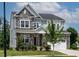 Charming two-story home featuring a stone facade, covered front porch, and a well-maintained front yard at 359 Abbot Pl, Chapel Hill, NC 27516